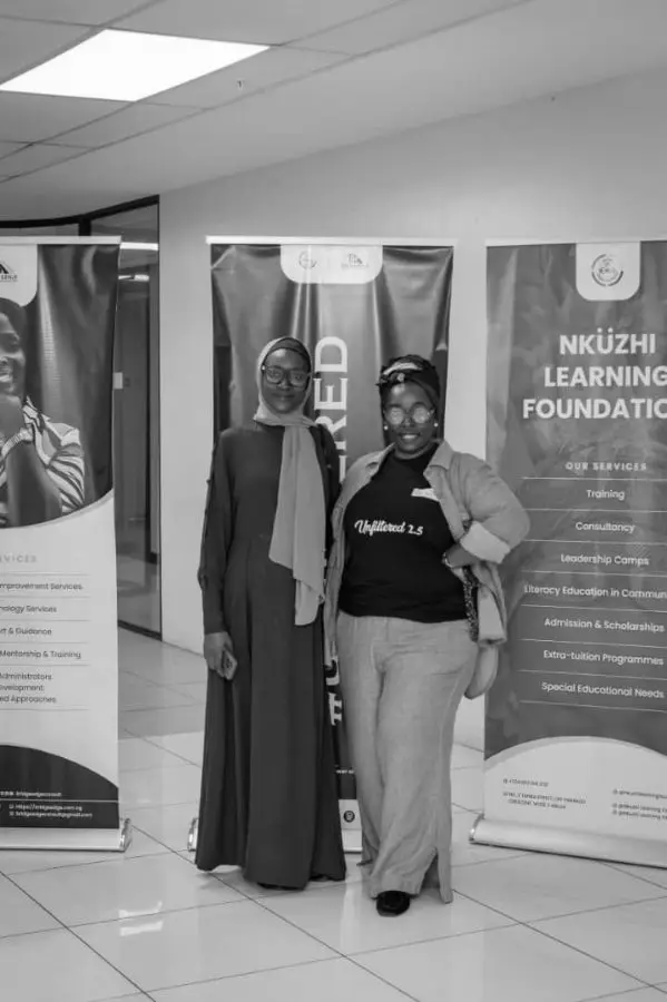 Facilitators beside the Nküzhi Learning Foundation banner